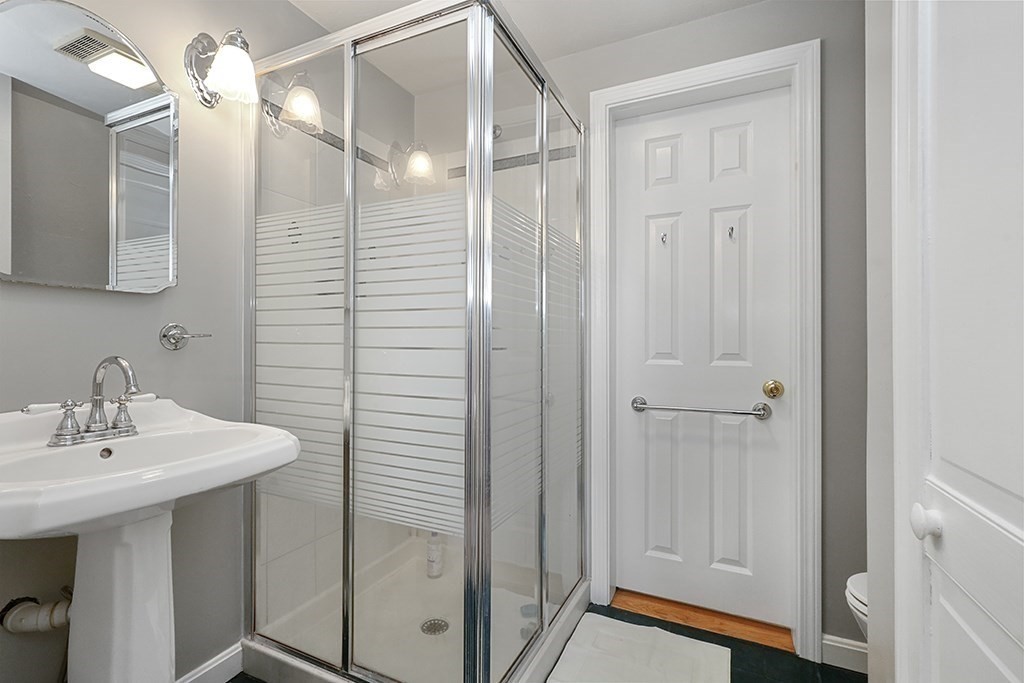 20 Maple Avenue Upton, MA 01568 - Photo 25 of 42 a bathroom with a sink a mirror a vanity and a shower