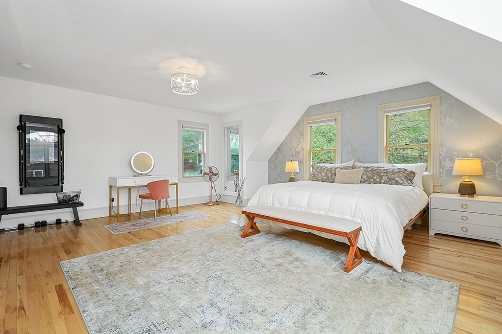 20 Maple Avenue Upton, MA 01568 - Photo 30 of 42 a spacious bedroom with a bed a table and a dresser next to a window