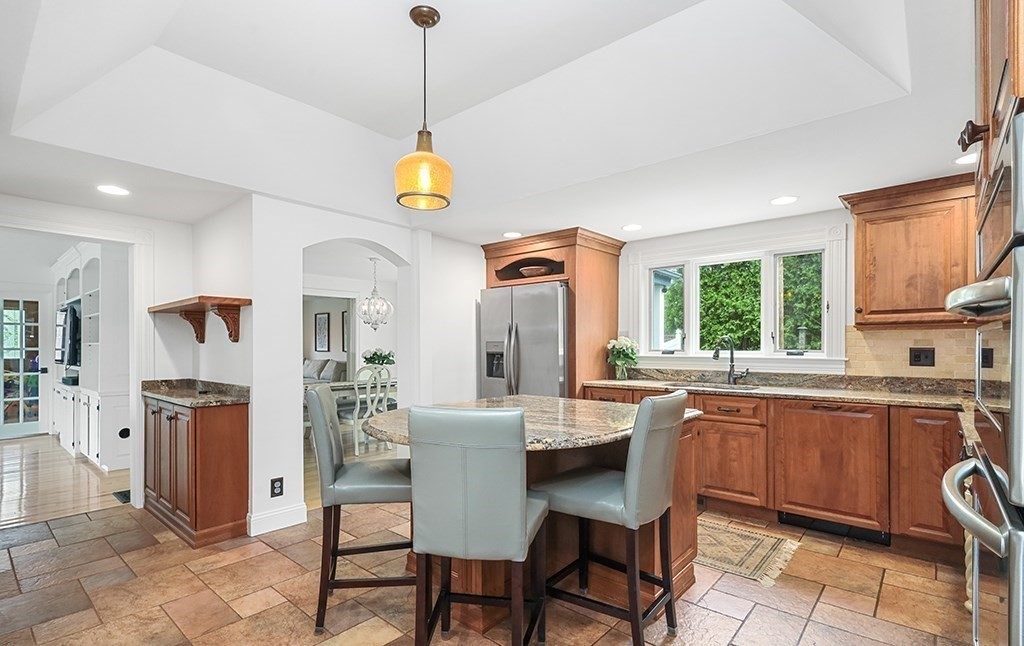 20 Maple Avenue Upton, MA 01568 - Photo 8 of 42 a view of a dining room and a kitchen with a chandelier