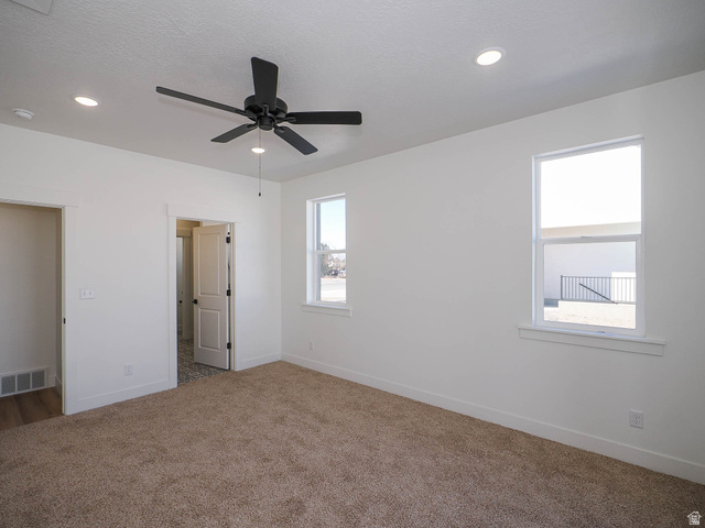 3938 North Wood Road Eagle Mountain, UT 84005 - Photo 17 of 55 Unfurnished bedroom with carpet, ceiling fan, and recessed lighting