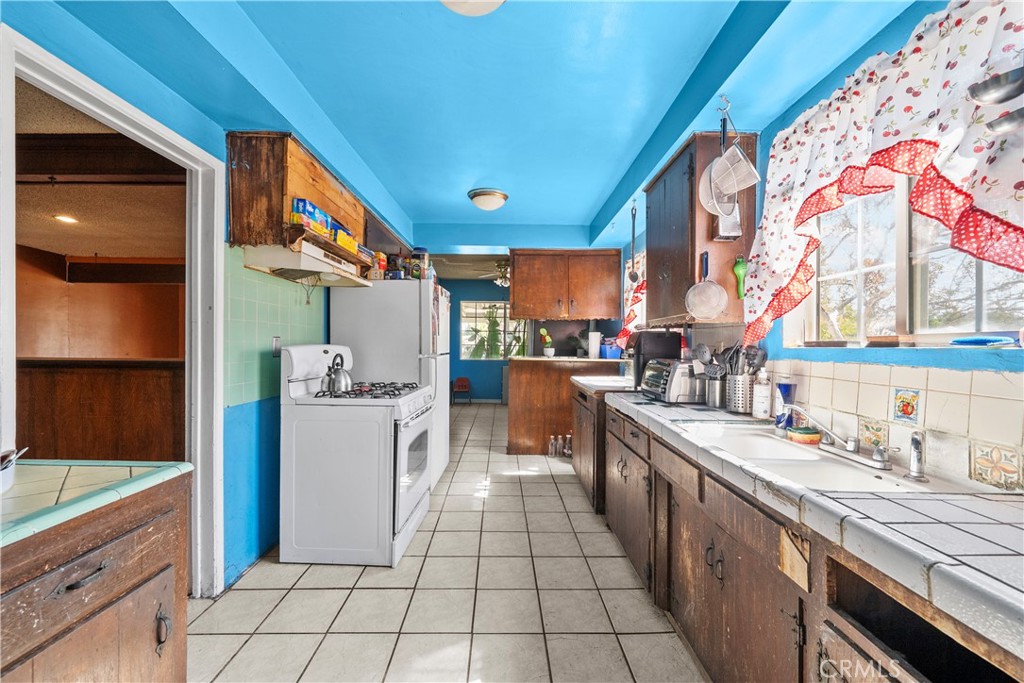 14930 Hubbard Street Sylmar, CA 91342 - Photo 12 of 22 a kitchen that has a lot of cabinets in it