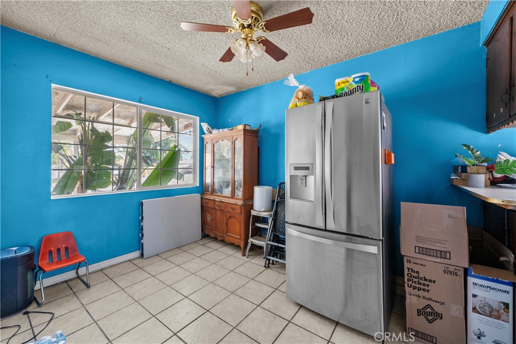 14930 Hubbard Street Sylmar, CA 91342 - Photo 13 of 22 a kitchen with stainless steel appliances granite countertop a refrigerator a microwave oven a sink and a dining table