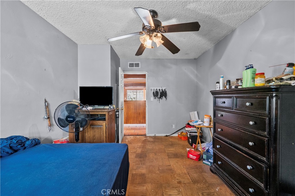 14930 Hubbard Street Sylmar, CA 91342 - Photo 17 of 22 a bed room with a bed and a television