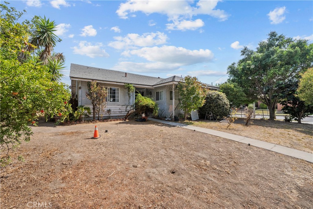 14930 Hubbard Street Sylmar, CA 91342 - Photo 2 of 22 a view of a house with backyard and a tree
