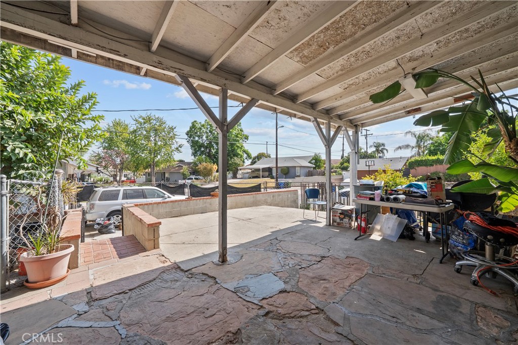 14930 Hubbard Street Sylmar, CA 91342 - Photo 4 of 22 a view of a patio with table and chairs potted plants