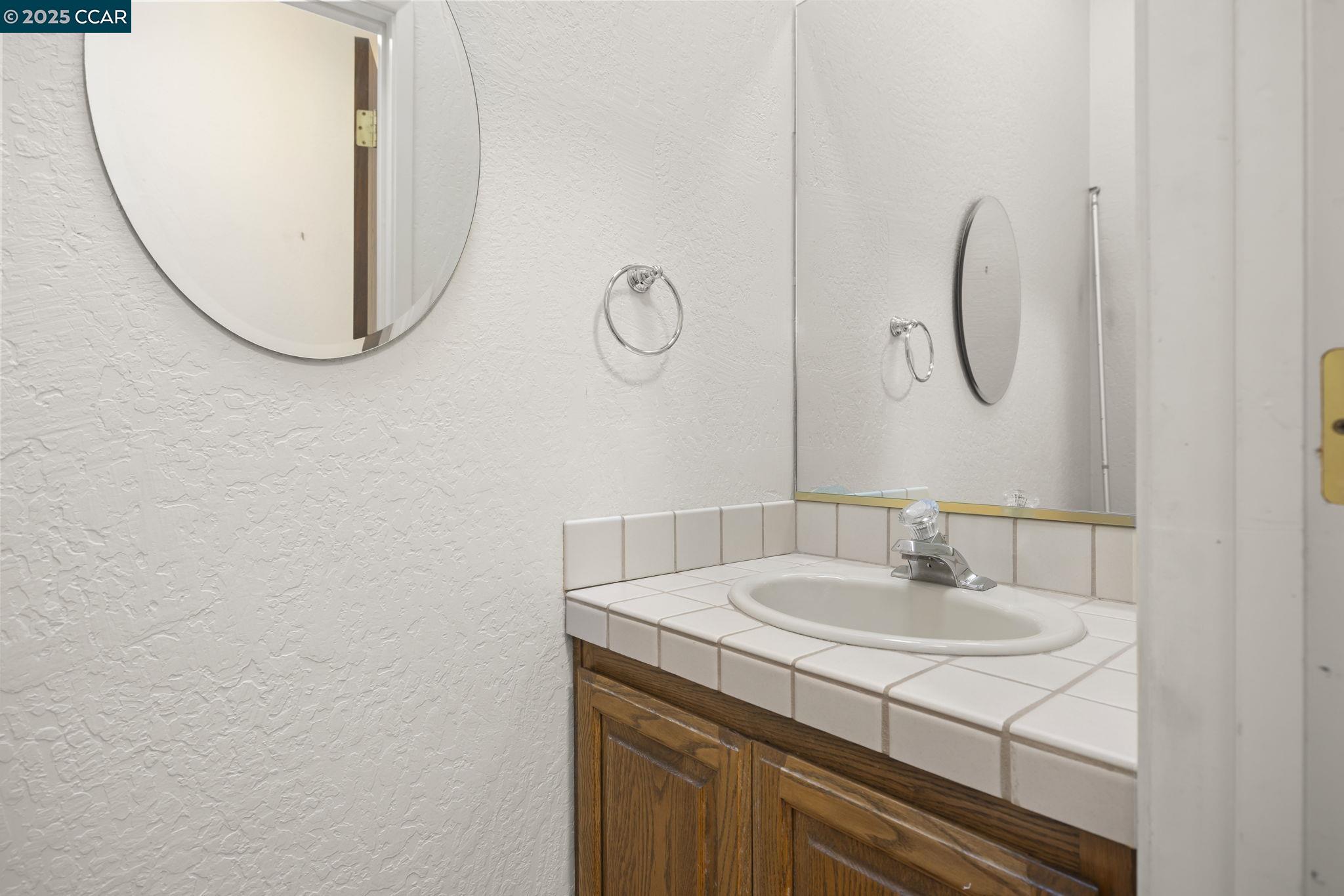 1383 Alvarado Road Berkeley, CA 94705 - Photo 18 of 47 a bathroom with a sink and mirror