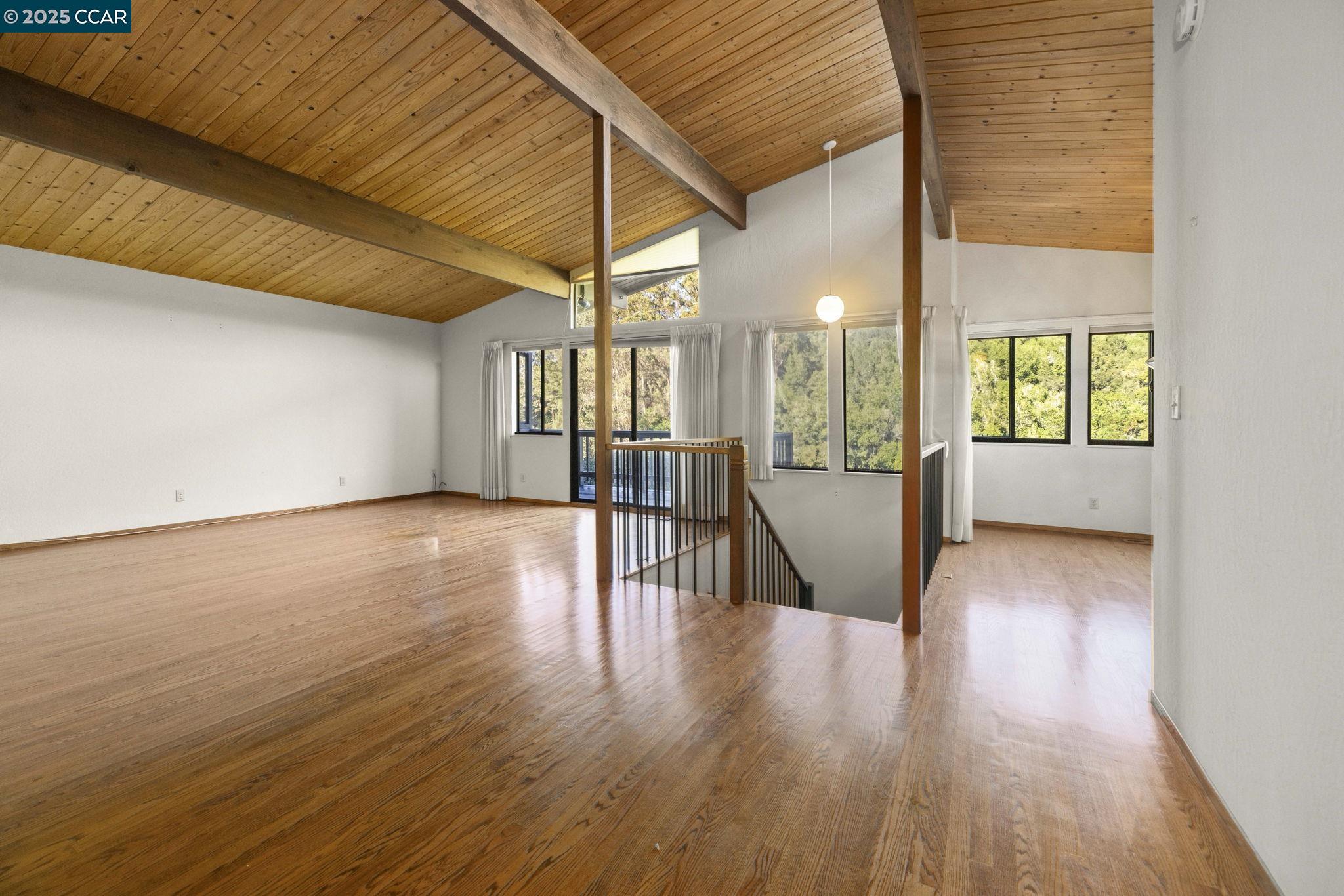 1383 Alvarado Road Berkeley, CA 94705 - Photo 7 of 47 wooden floor in an empty room with a window