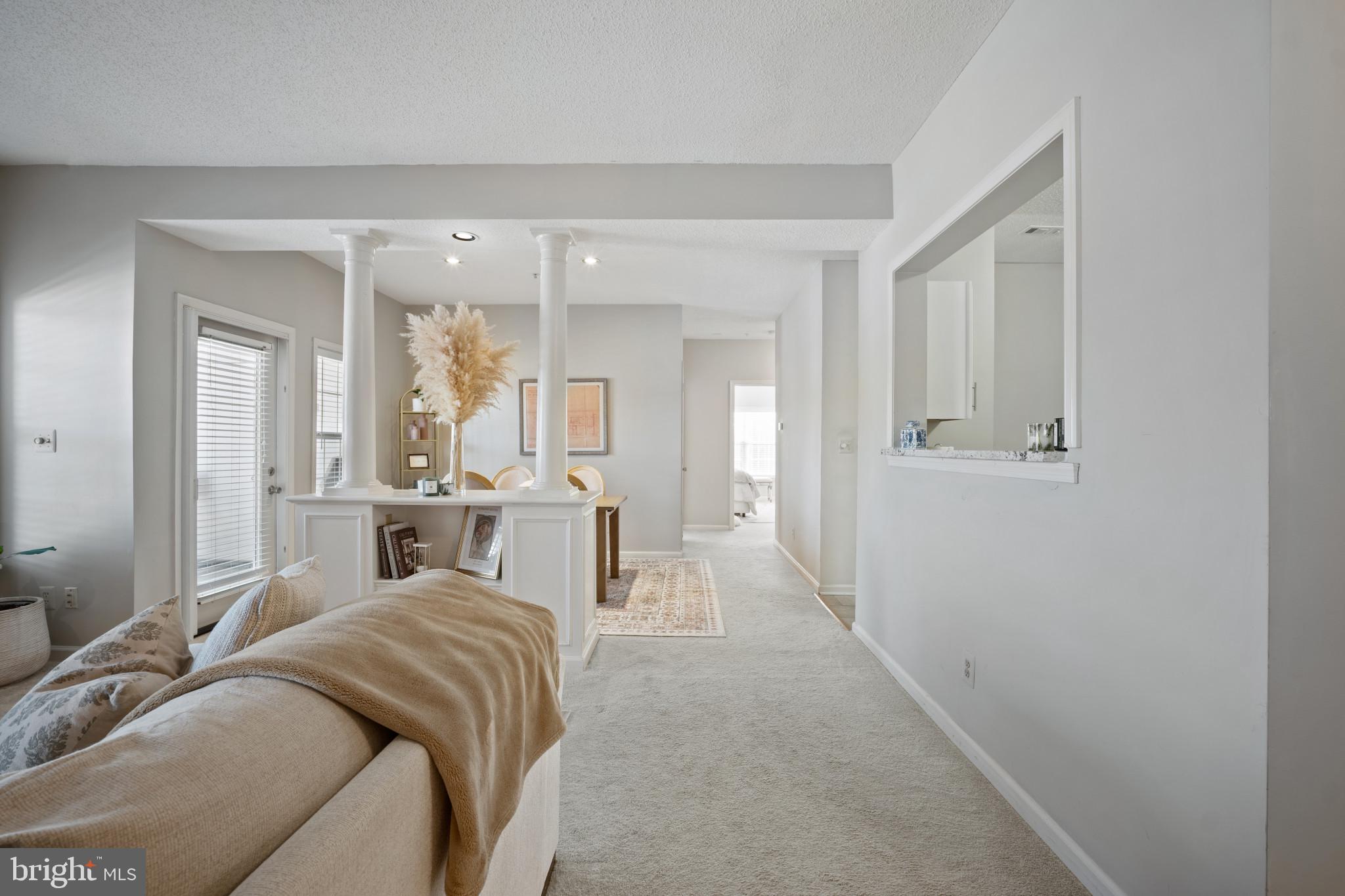 1724 Lake Shore Crest Drive, Unit 25 Reston, VA 20190 - Photo 14 of 52 a living room with furniture and a table