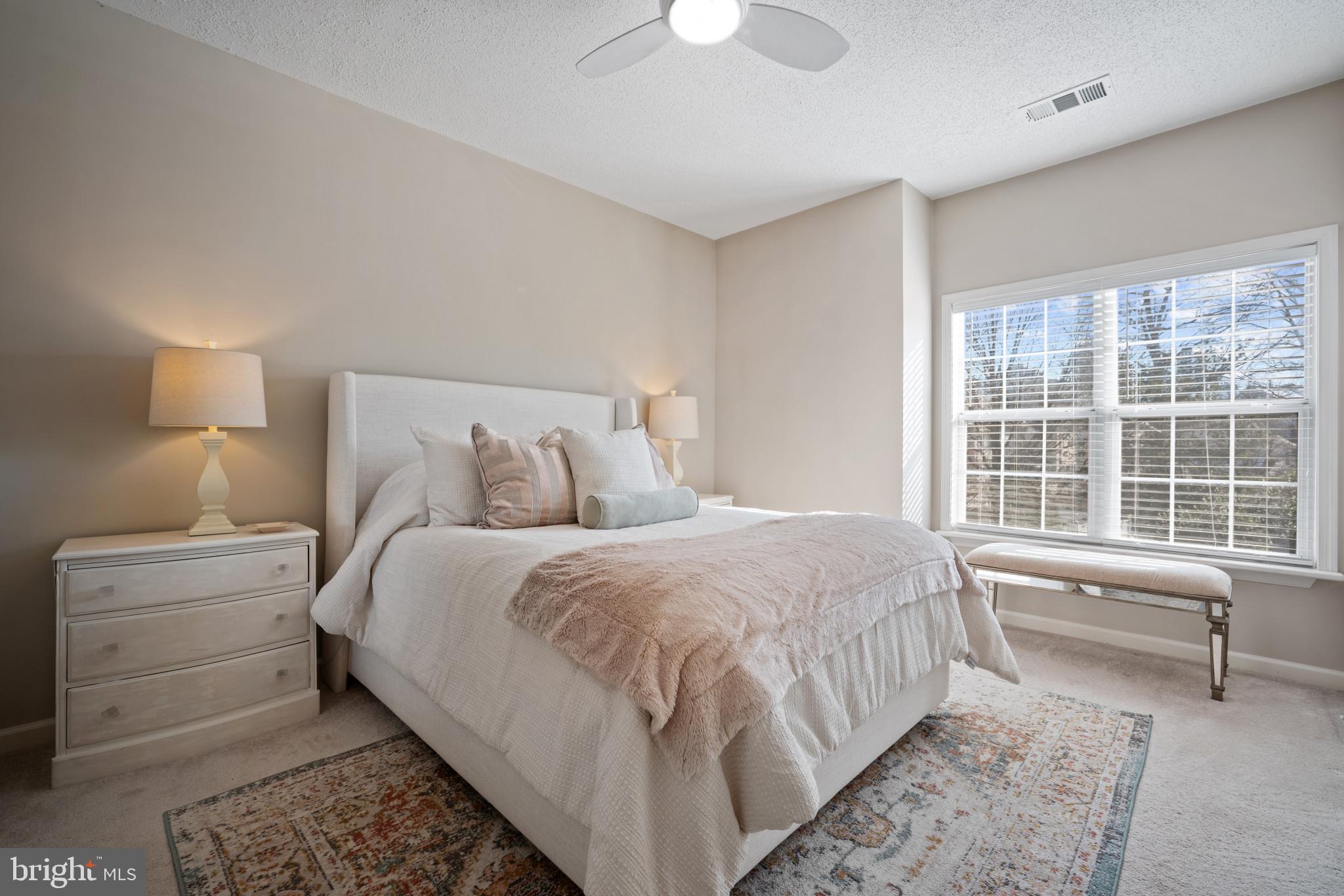 1724 Lake Shore Crest Drive, Unit 25 Reston, VA 20190 - Photo 18 of 52 a bedroom with a bed and a large window
