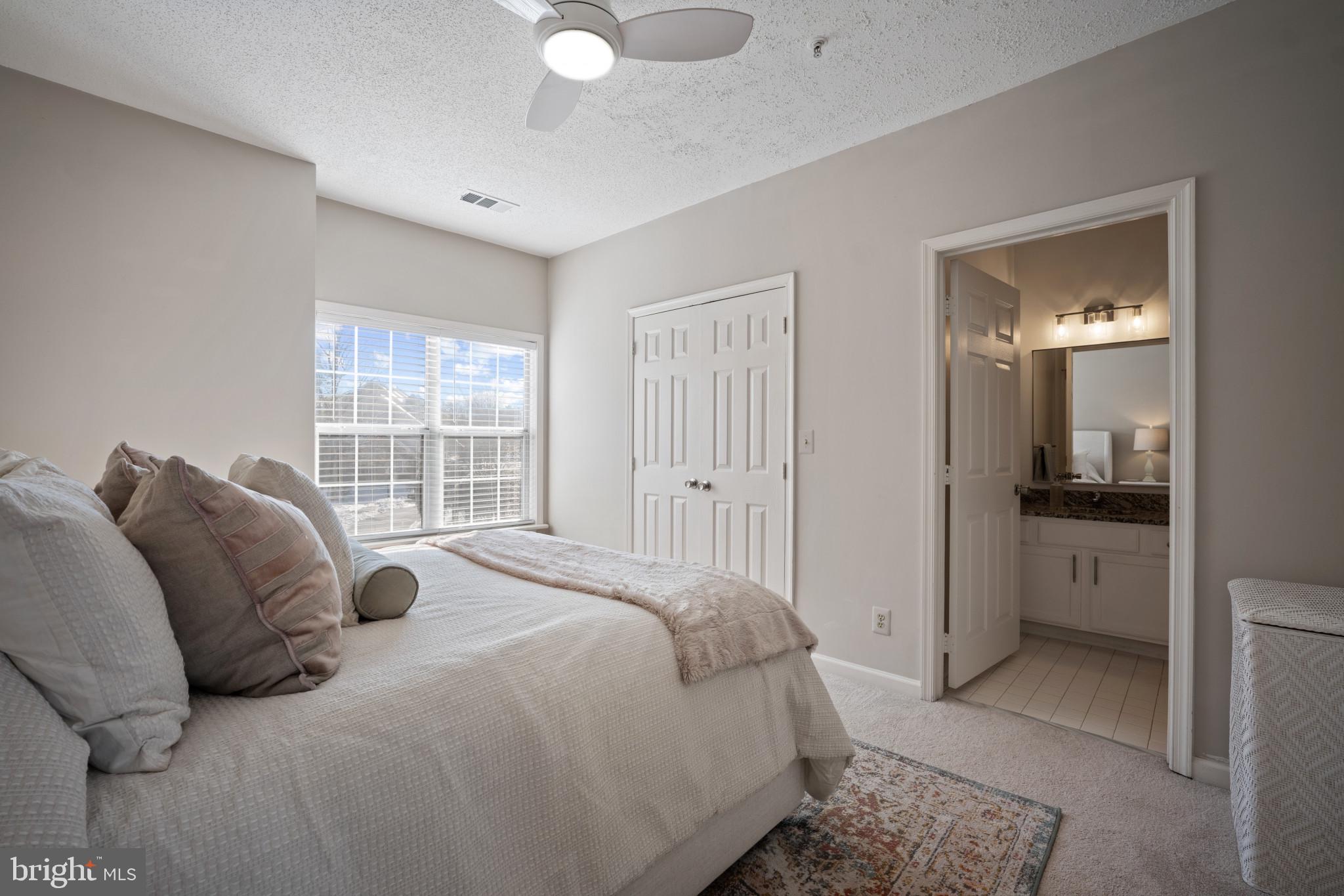 1724 Lake Shore Crest Drive, Unit 25 Reston, VA 20190 - Photo 19 of 52 a bedroom with a bed and a mirror