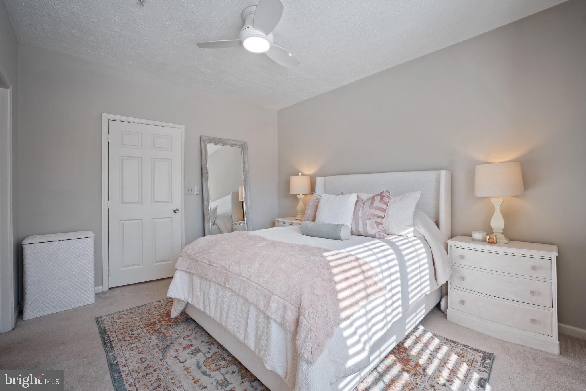 1724 Lake Shore Crest Drive, Unit 25 Reston, VA 20190 - Photo 20 of 52 a bedroom with a bed and a lamp with the wooden floor