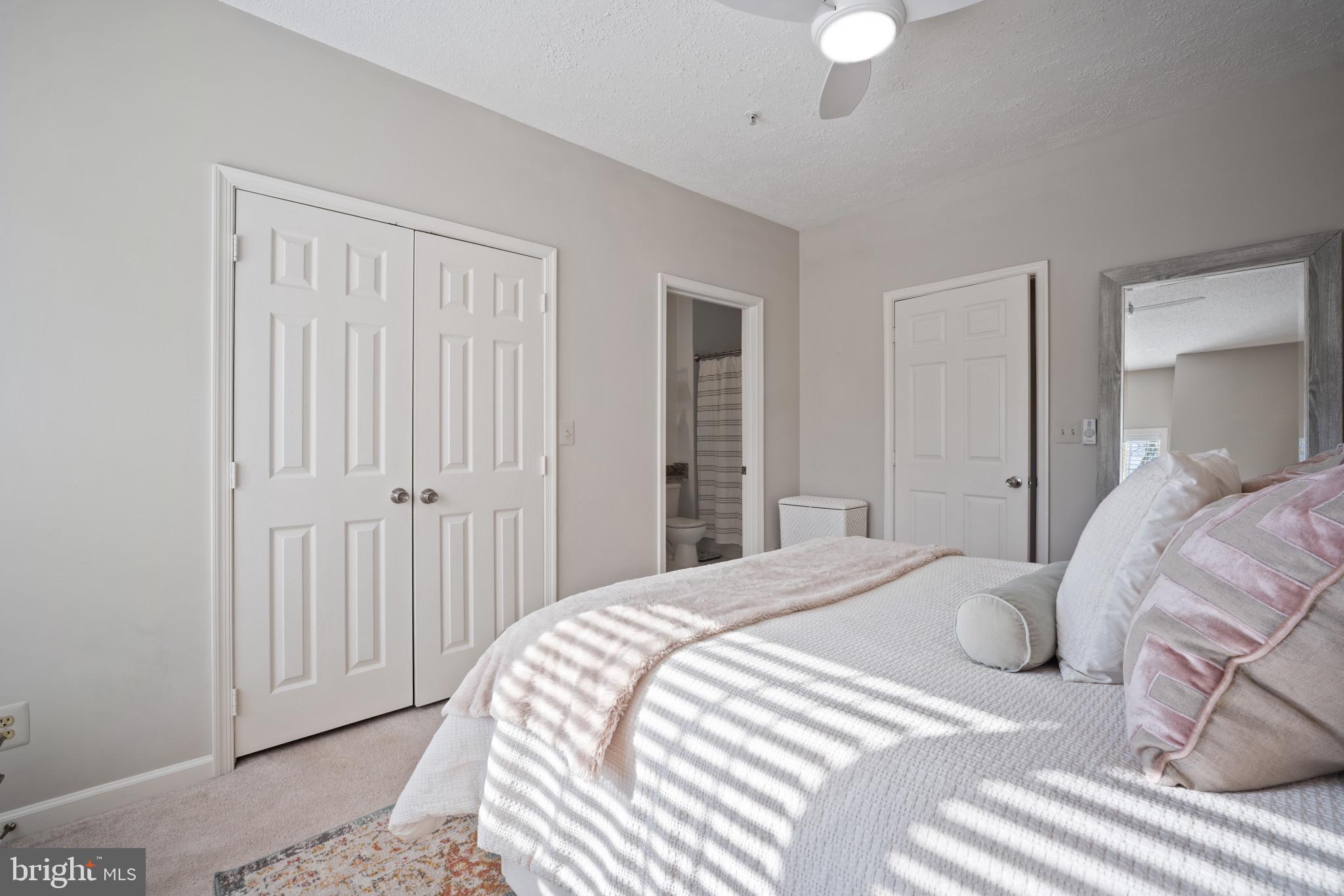 1724 Lake Shore Crest Drive, Unit 25 Reston, VA 20190 - Photo 21 of 52 a bedroom with a bed and a chandelier