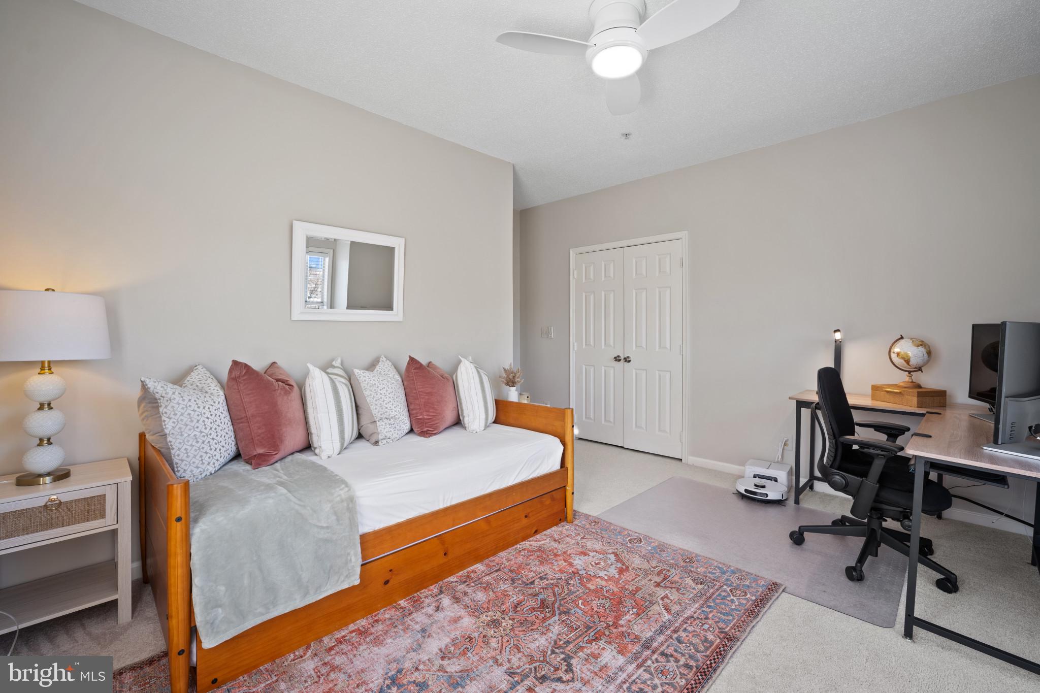 1724 Lake Shore Crest Drive, Unit 25 Reston, VA 20190 - Photo 28 of 52 a bedroom with a bed and a desk