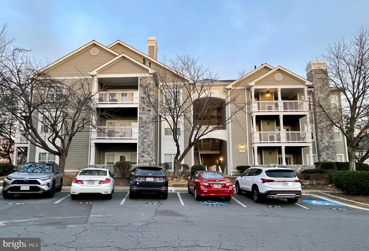 1724 Lake Shore Crest Drive, Unit 25 Reston, VA 20190 - Photo 31 of 52 a front view of a house with parking space