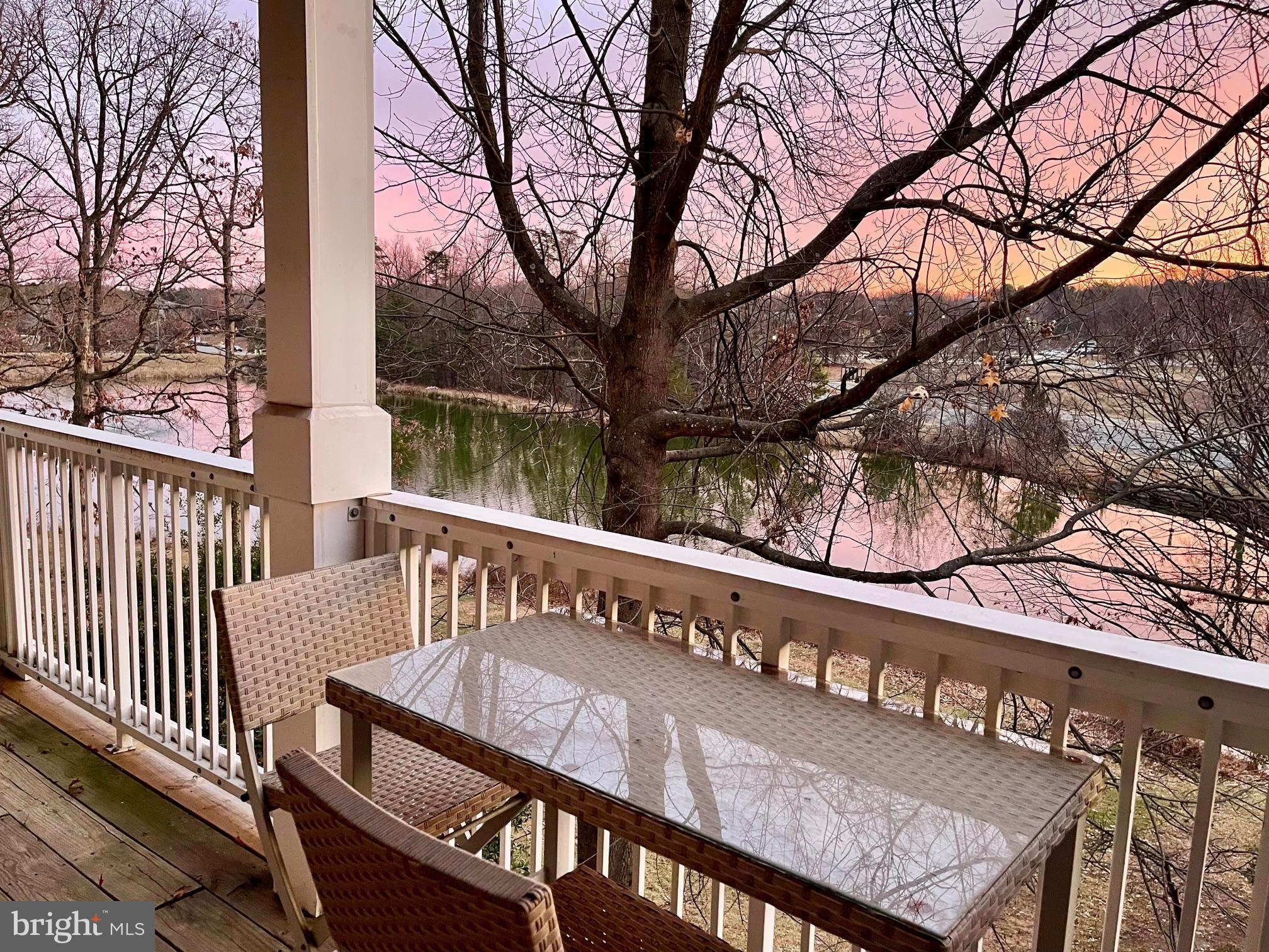 1724 Lake Shore Crest Drive, Unit 25 Reston, VA 20190 - Photo 32 of 52 a view of a wooden bench under an umbrella