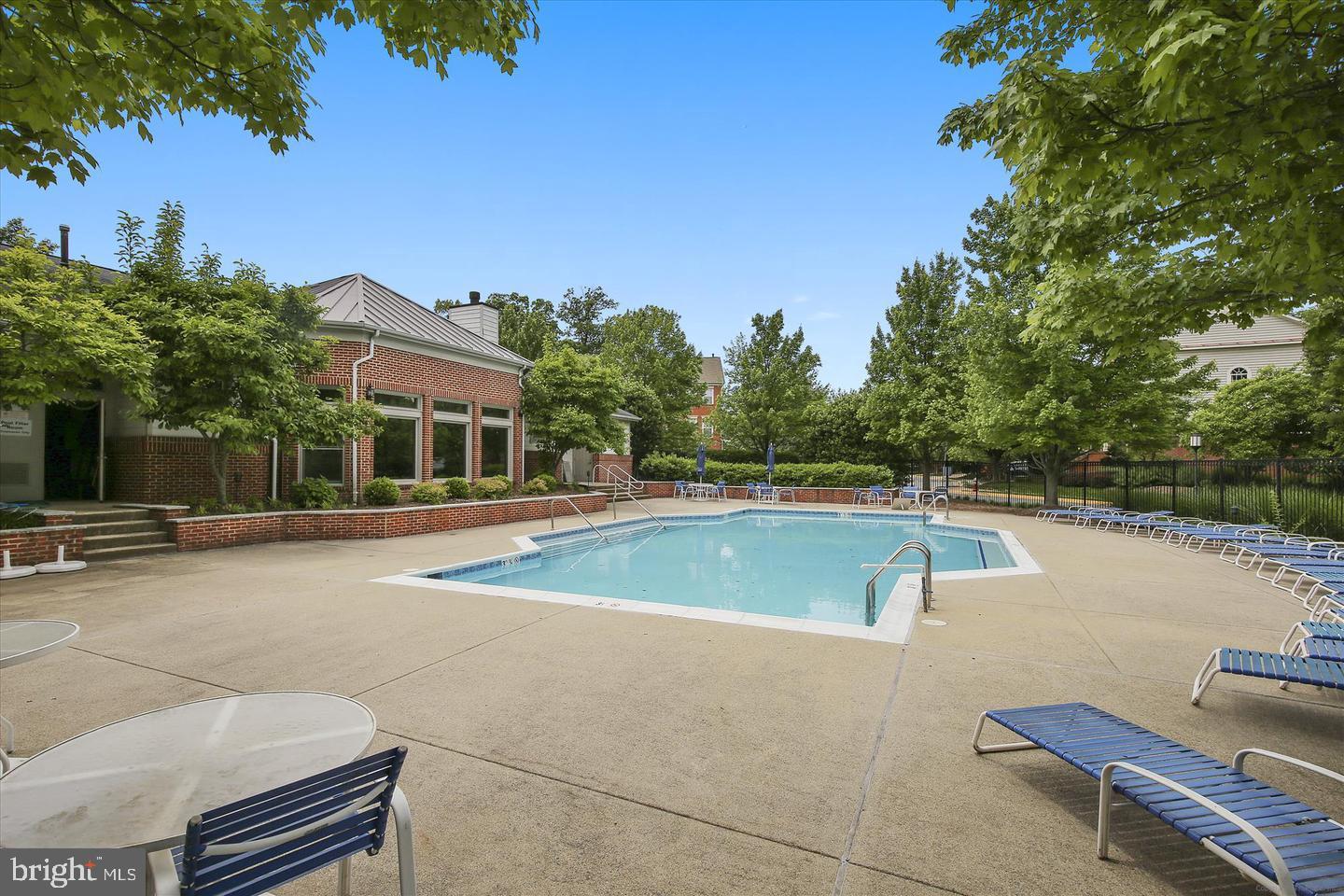 1724 Lake Shore Crest Drive, Unit 25 Reston, VA 20190 - Photo 36 of 52 a view of a swimming pool with lounge chair