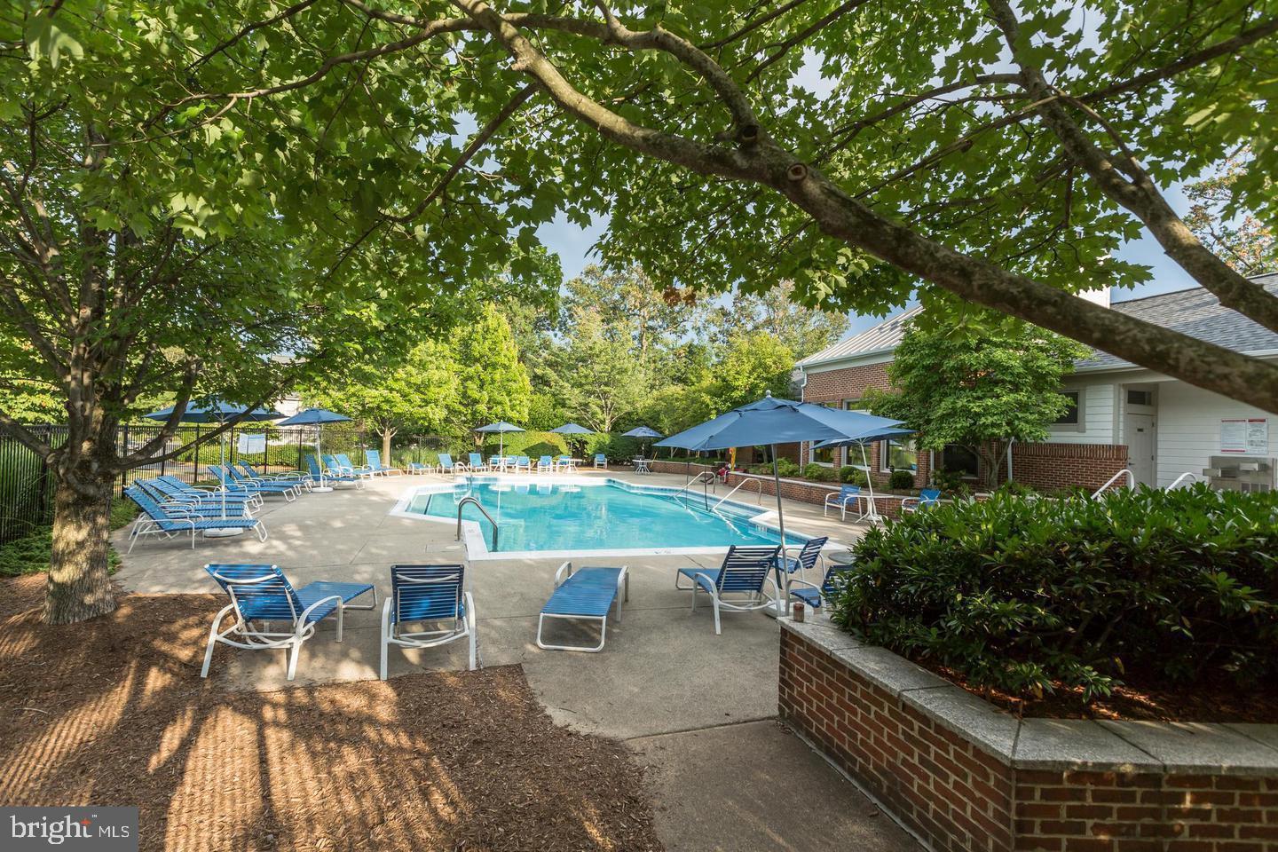 1724 Lake Shore Crest Drive, Unit 25 Reston, VA 20190 - Photo 37 of 52 a view of a patio with table and chairs and potted plants