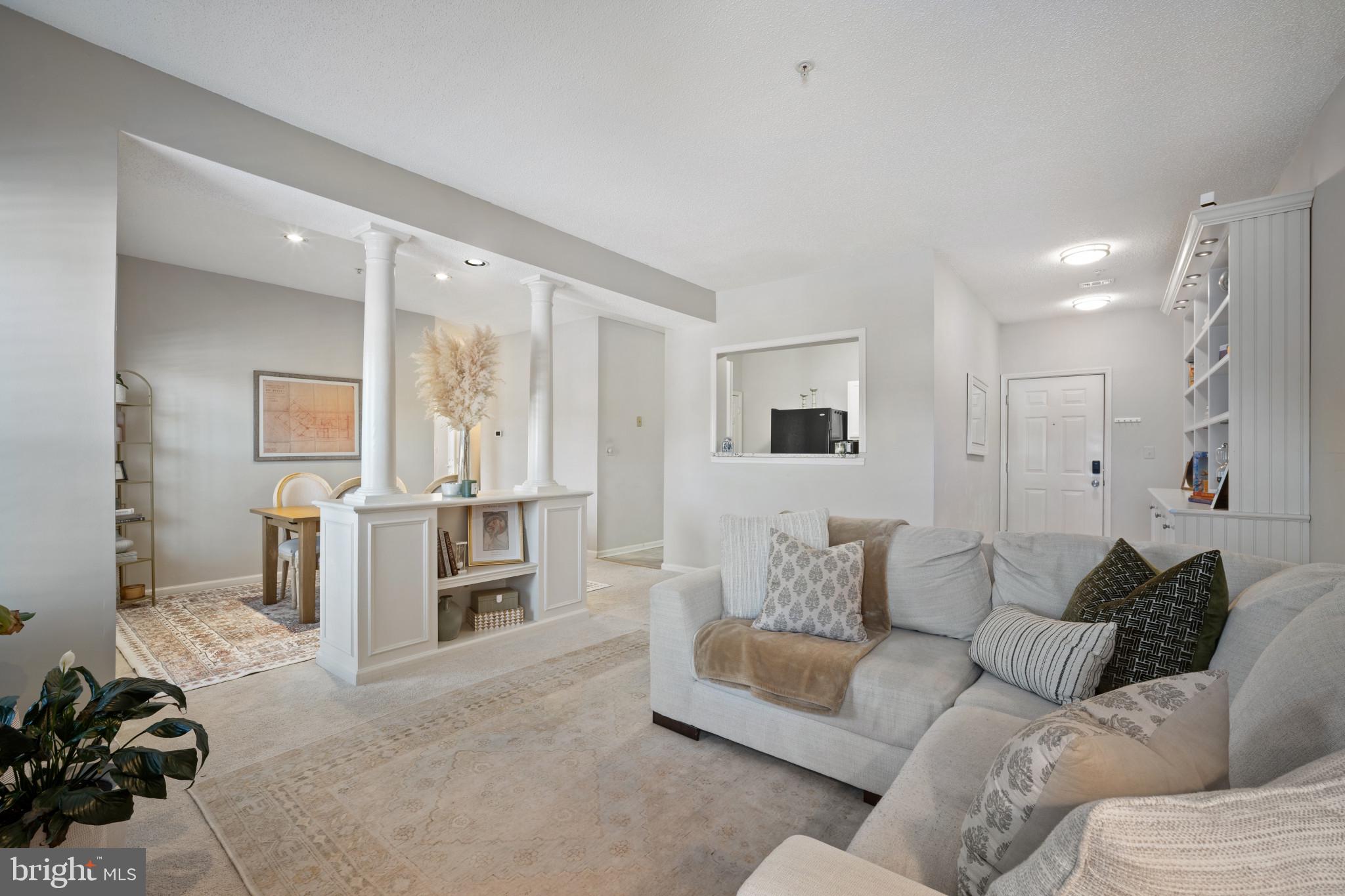 1724 Lake Shore Crest Drive, Unit 25 Reston, VA 20190 - Photo 4 of 52 a living room with furniture and large windows