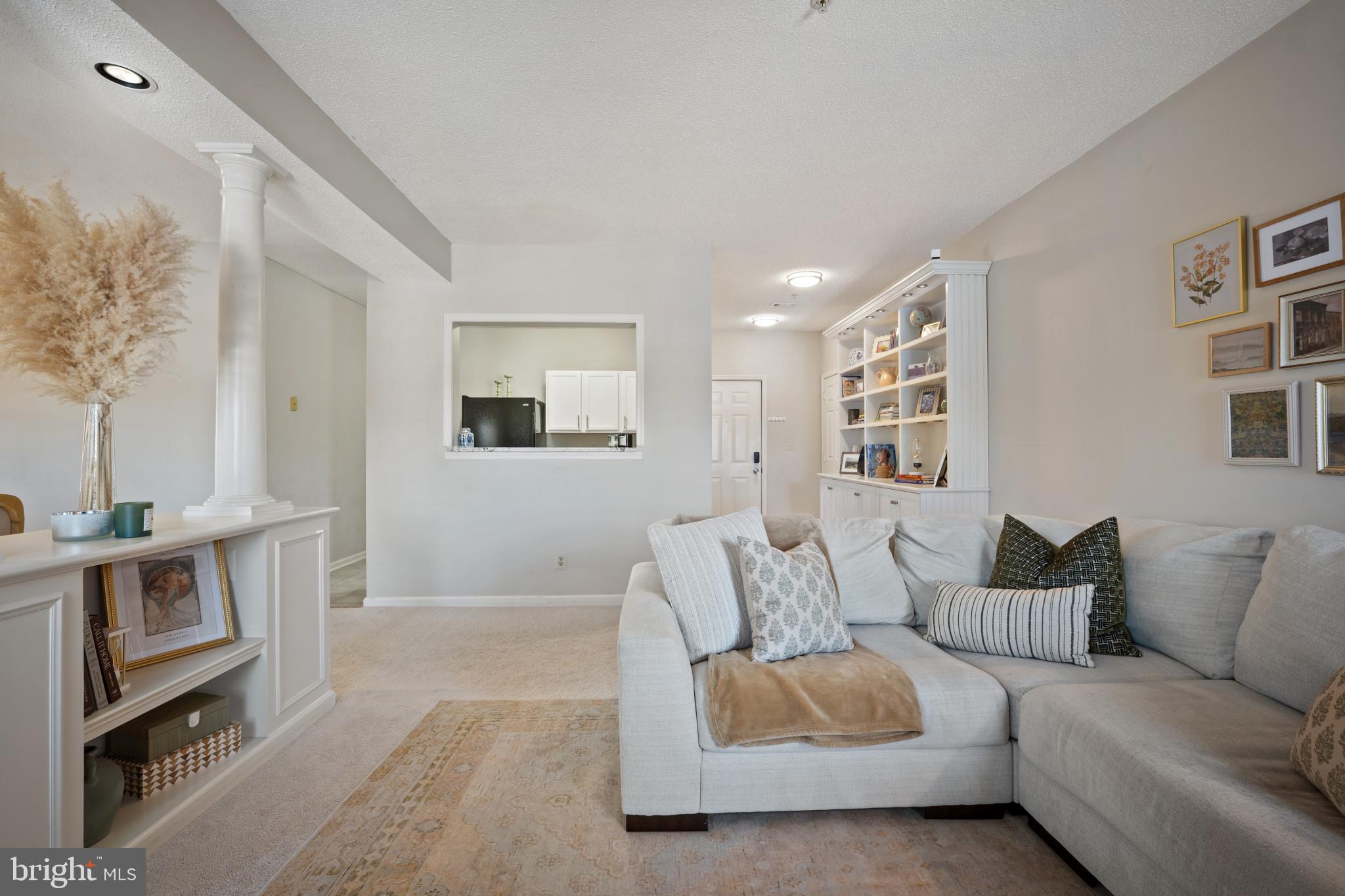 1724 Lake Shore Crest Drive, Unit 25 Reston, VA 20190 - Photo 8 of 52 a living room with furniture and a flat screen tv