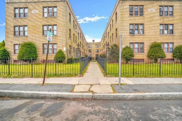 a view of a brick building next to a yard