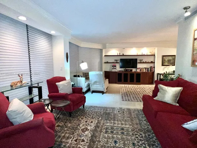 a living room with furniture a rug and a window