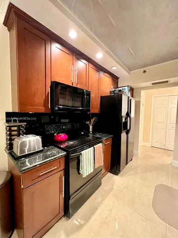 a dining room with furniture and floor to ceiling window