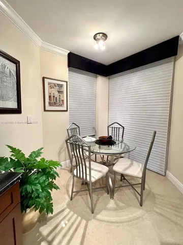 a view of a dining room with furniture and a potted plant
