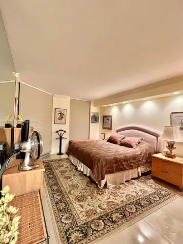 a bed room with a bed and a television