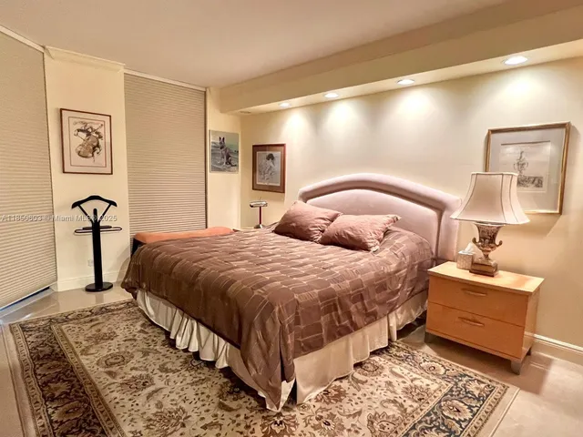 a bedroom with a bed and a television