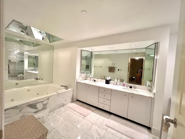 a bathroom with a sink vanity mirror and toilet