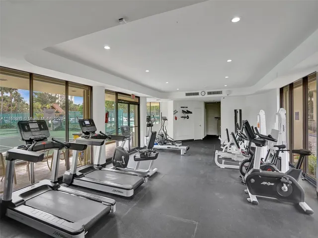 a bedroom with a bed and a large mirror on the dresser