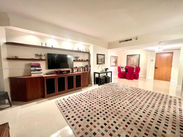 a large bedroom with a bed and a television