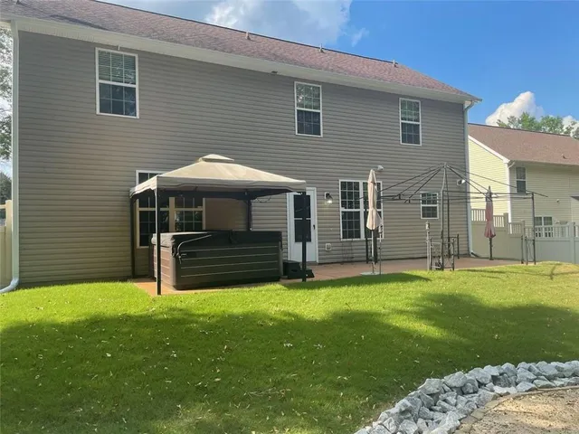 a view of a house with a yard and sitting area