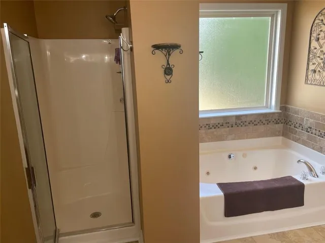 a bathroom with a bathtub and shower