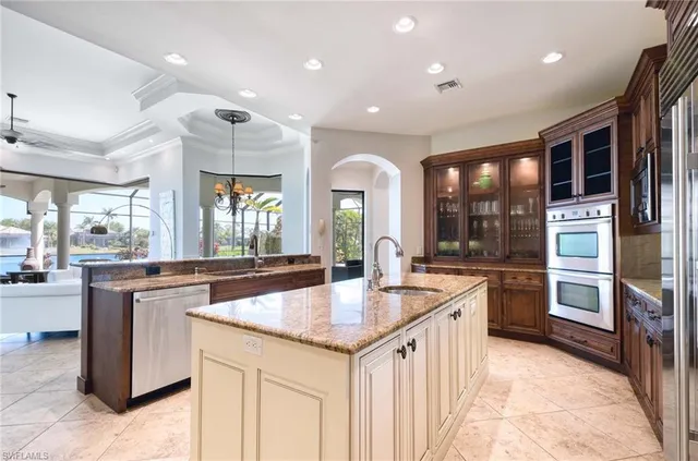 a kitchen with stainless steel appliances granite countertop a stove top oven sink and cabinets