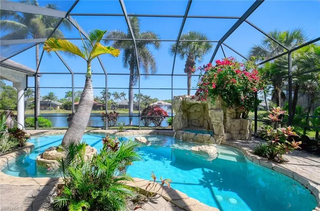 a living room with couches a fireplace and a dining table with wooden floor