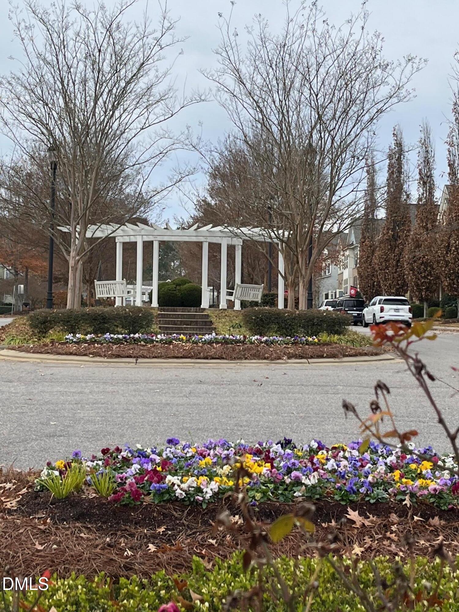1517 Crafton Way Raleigh, NC 27607 - Photo 27 of 28 a front view of a house with lots of flowers and trees