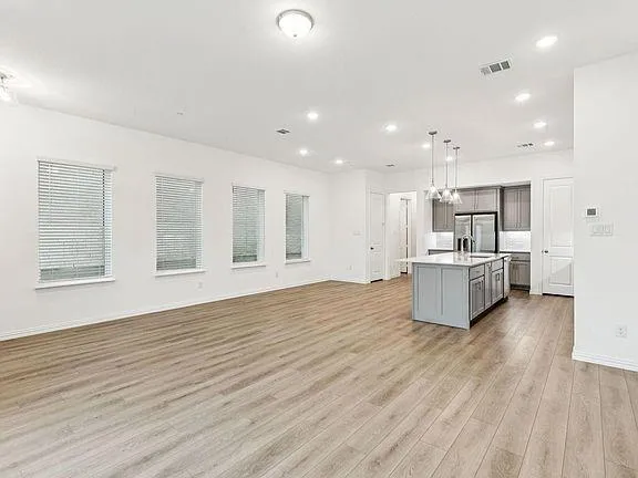 a view of kitchen with wooden floor and windows