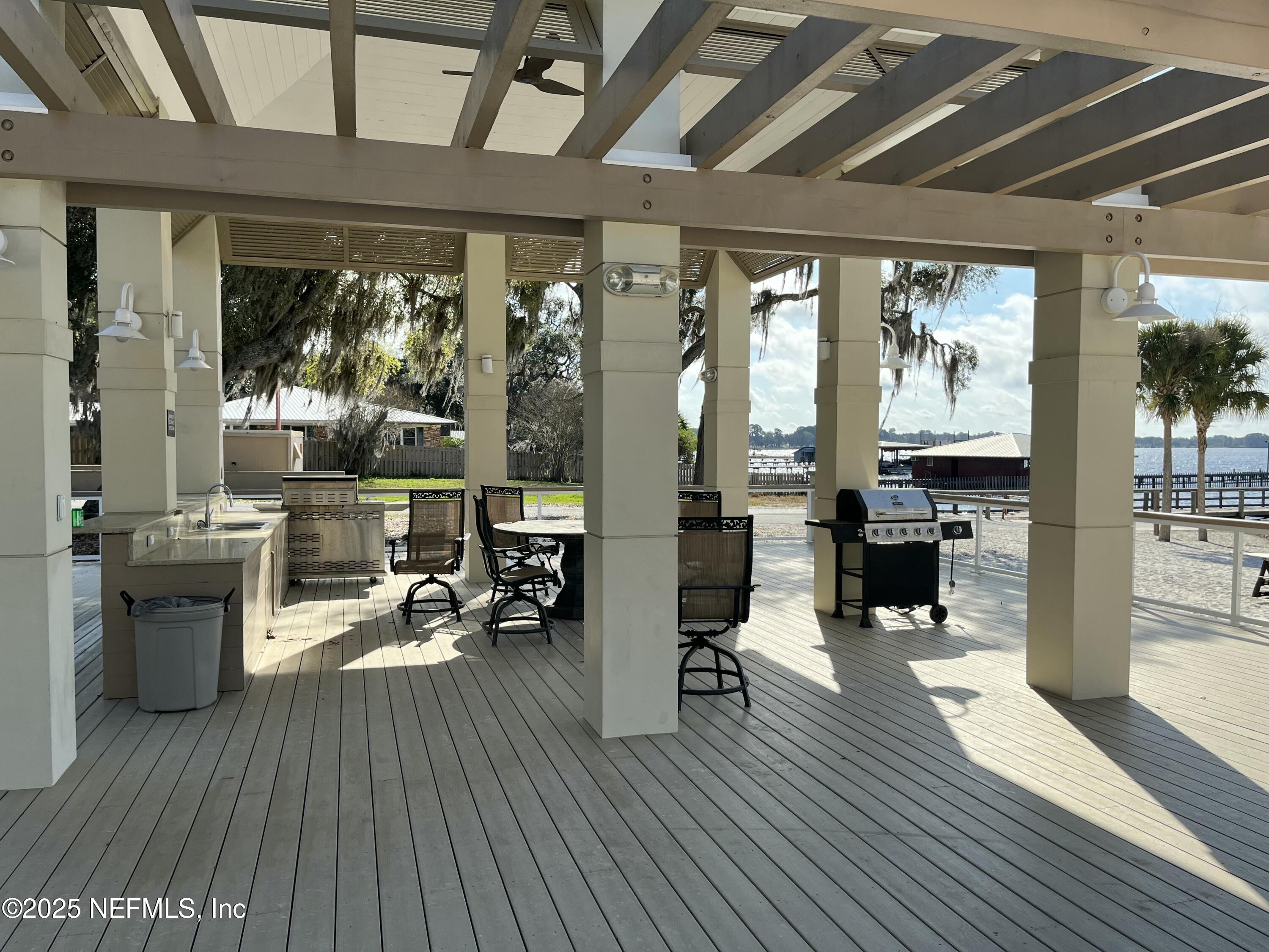6486 Cabana Trace Starke, FL 32091 - Photo 10 of 16 a living room with furniture a wooden floor and a large window