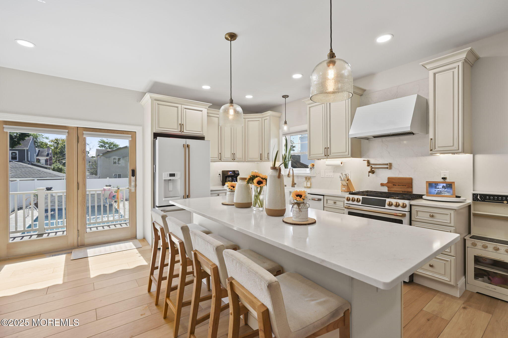 128 1st Street Keyport, NJ 07735 - Photo 4 of 38 a kitchen with stainless steel appliances granite countertop a stove a refrigerator a sink dishwasher a dining table and chairs with wooden floor