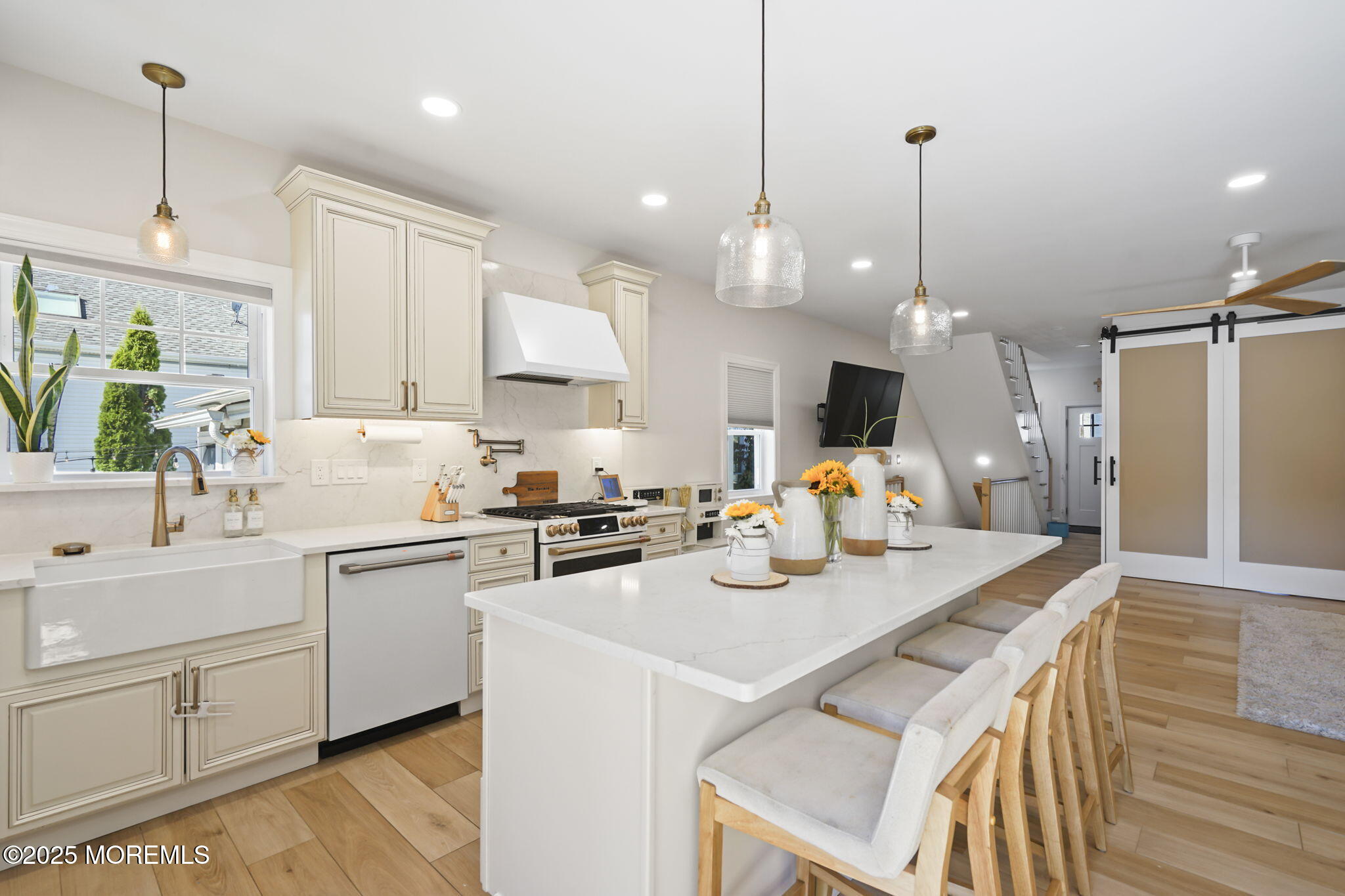 128 1st Street Keyport, NJ 07735 - Photo 6 of 38 a kitchen with a sink a stove a refrigerator and white cabinets