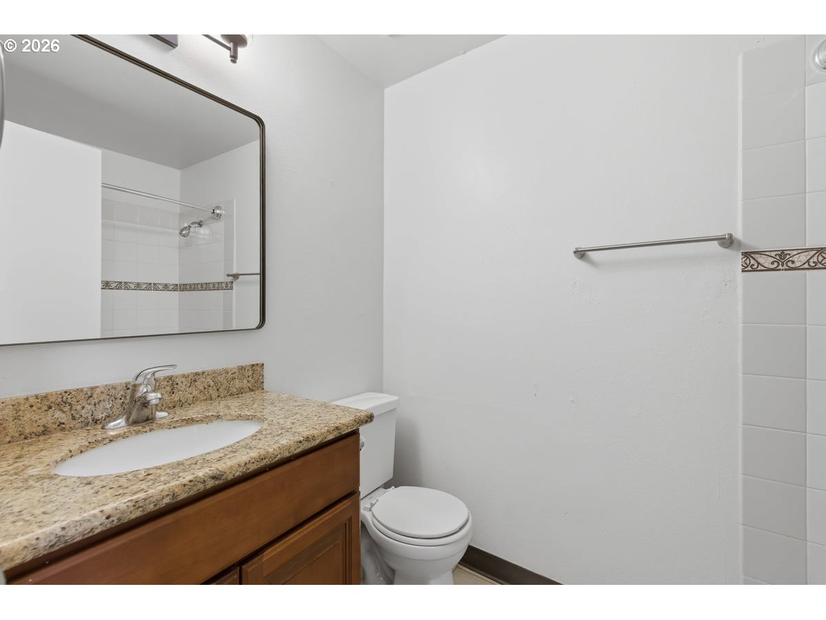 2137 Southeast 130th Avenue Portland, OR 97233 - Photo 11 of 14 a bathroom with a granite countertop sink toilet and mirror