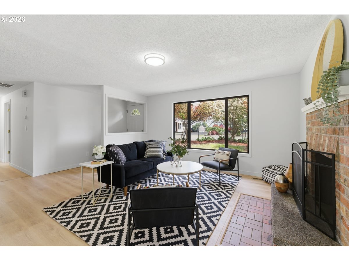 2137 Southeast 130th Avenue Portland, OR 97233 - Photo 2 of 14 a living room with furniture fireplace and a large window