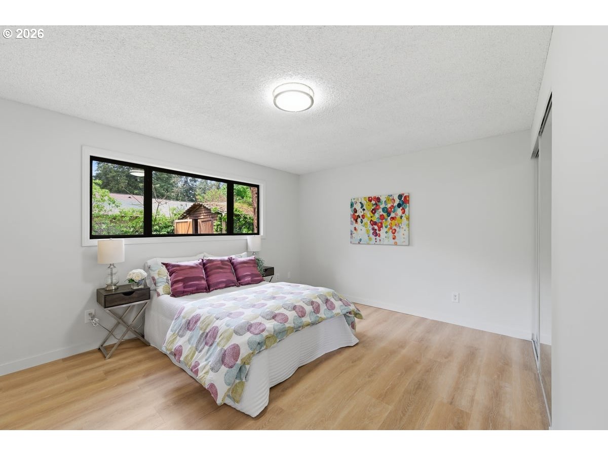 2137 Southeast 130th Avenue Portland, OR 97233 - Photo 7 of 14 a bedroom with a bed and a large window