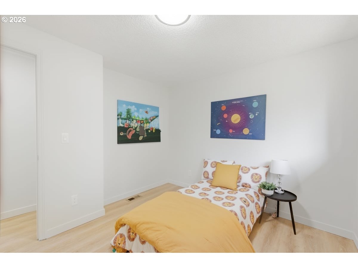 2137 Southeast 130th Avenue Portland, OR 97233 - Photo 9 of 14 a bedroom with a bed and a table