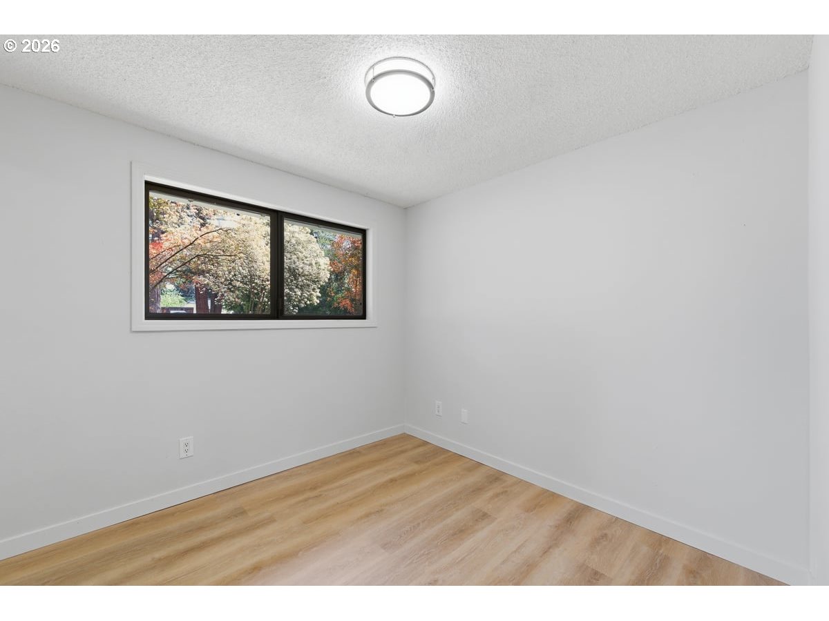 2137 Southeast 130th Avenue Portland, OR 97233 - Photo 10 of 14 a view of empty room with wooden floor