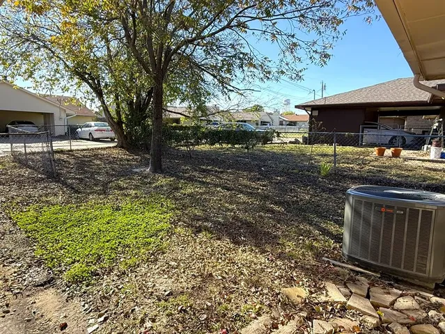 a view of a backyard with large trees
