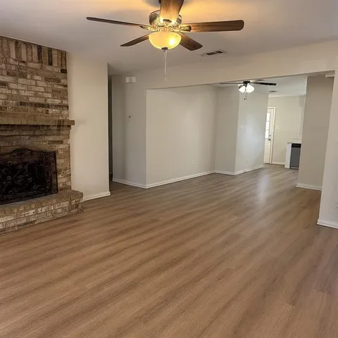 wooden floor in an empty room with a fireplace