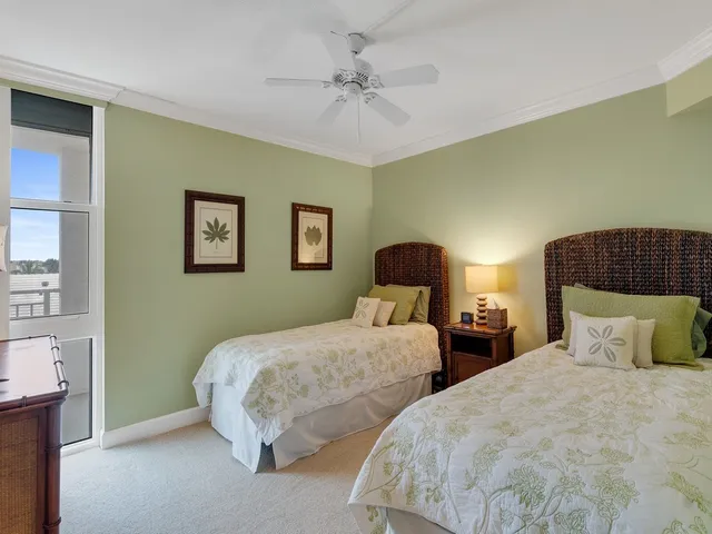 a bedroom with two beds and painting on the wall