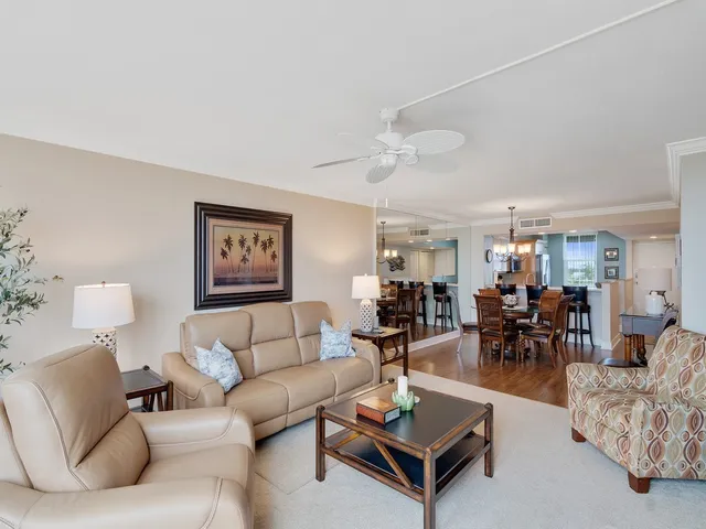 a living room with furniture a rug and a chandelier